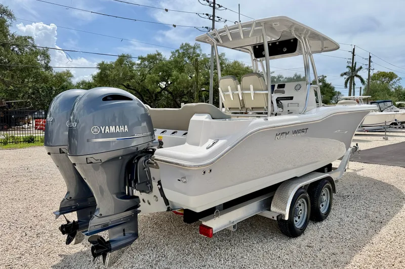 Slide: The Image of 2021 Key West 263 FS boat with dual Yamaha engines on a trailer. - 5