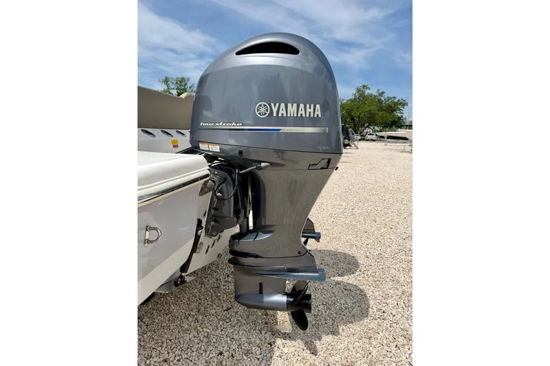 Slide: The Image of 2021 Key West 263 FS boat with Yamaha four-stroke outboard motor in a gravel lot. - 50