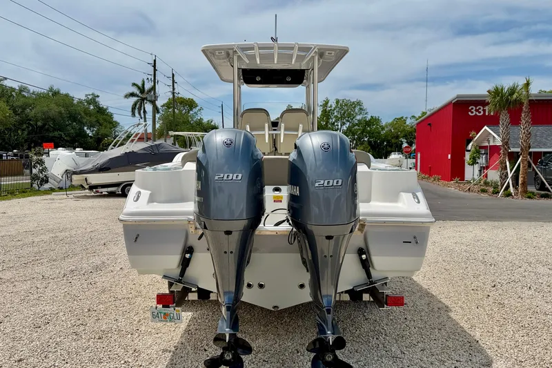 Slide: The Image of 2021 Key West 263 FS boat with dual Yamaha 200 engines, parked outdoors. - 6