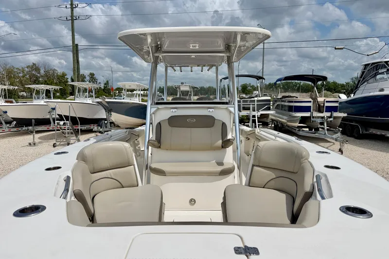 Slide: The Image of 2021 Key West 263 FS boat with spacious seating, displayed in a marina setting. - 8