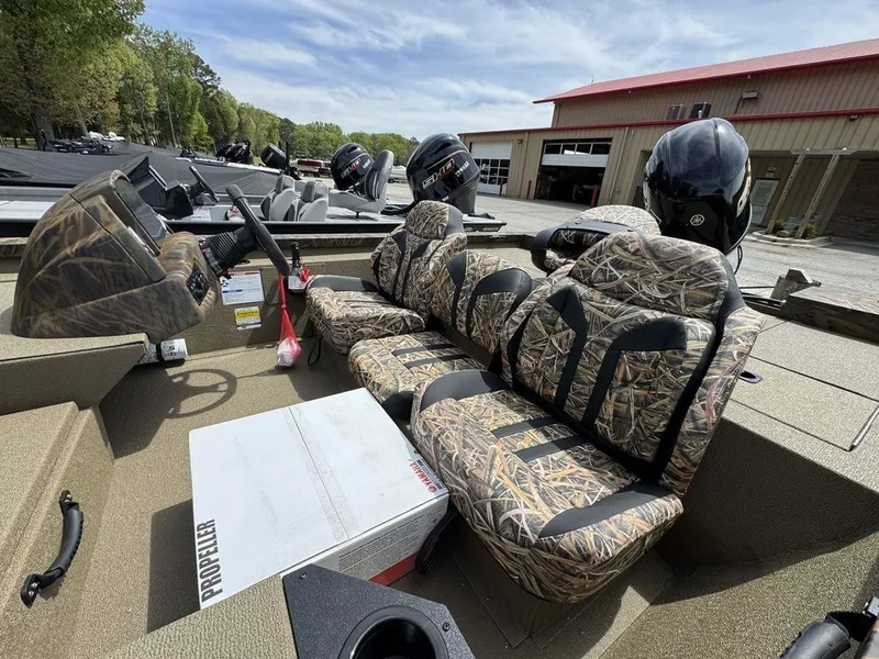 Slide: The Image of 2026 G3 Sportsman 1810 PFX boat with camo-pattern seats outdoors. - 2