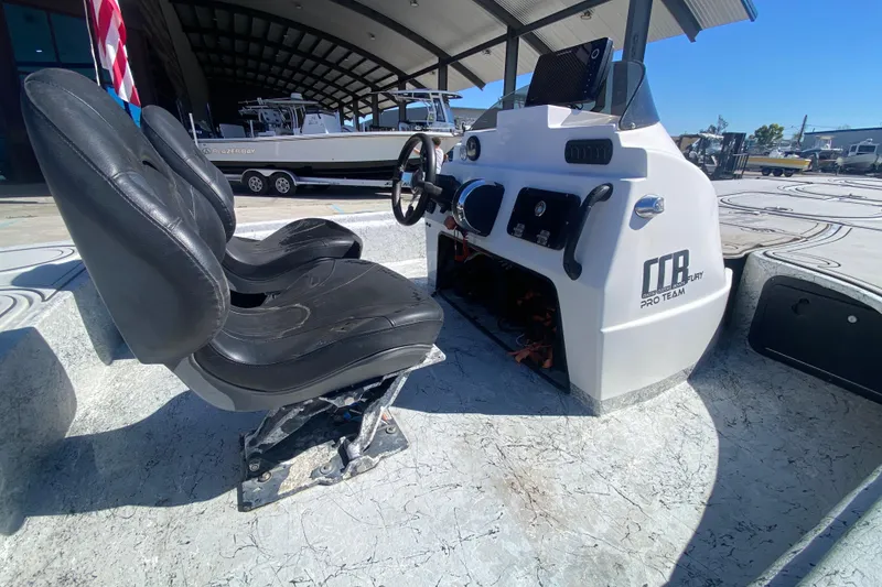 Slide: The Image of Interior of 2020 Coastal Custom Boats 23' Fury, featuring dual black seats and control console. - 12