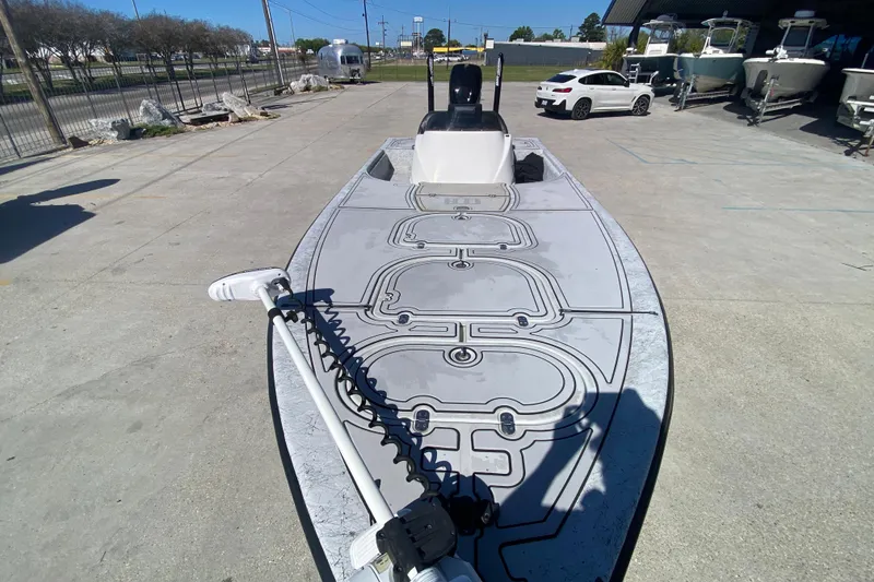 Slide: The Image of 2020 Coastal Custom Boats 23' Fury with sleek deck design in a boatyard setting. - 14