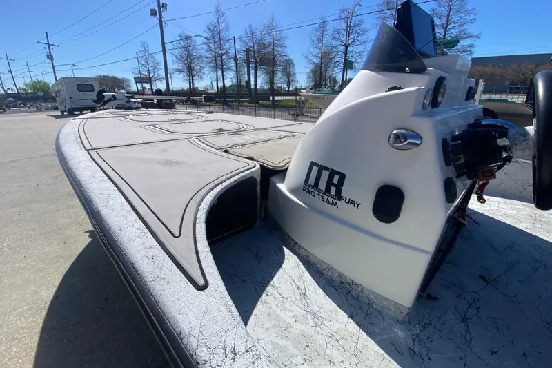 Slide: The Image of 2020 Coastal Custom Boats 23' Fury, sleek design, parked outdoors under clear blue sky. - 16