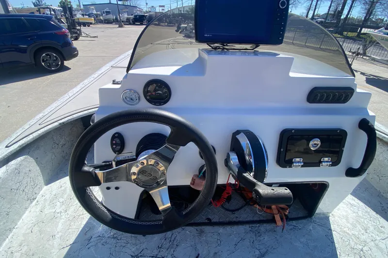 Slide: The Image of 2020 Coastal Custom Boats 23' Fury dashboard with steering wheel and controls. - 20