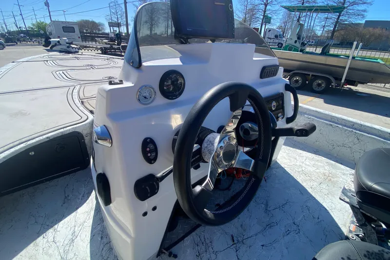 Slide: The Image of Steering console of a 2020 Coastal Custom Boats 23' Fury, featuring modern controls and gauges. - 21