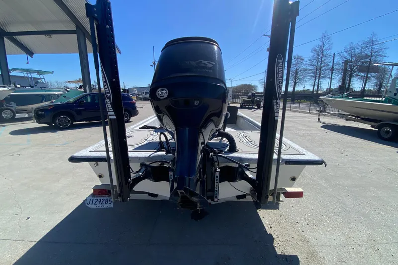 Slide: The Image of 2020 Coastal Custom Boats 23' Fury with powerful outboard motor, parked outdoors. - 5