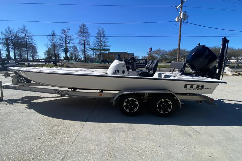 Slide: The Image of 2020 Coastal Custom Boats 23' Fury on trailer, parked outdoors under clear blue sky. - 7