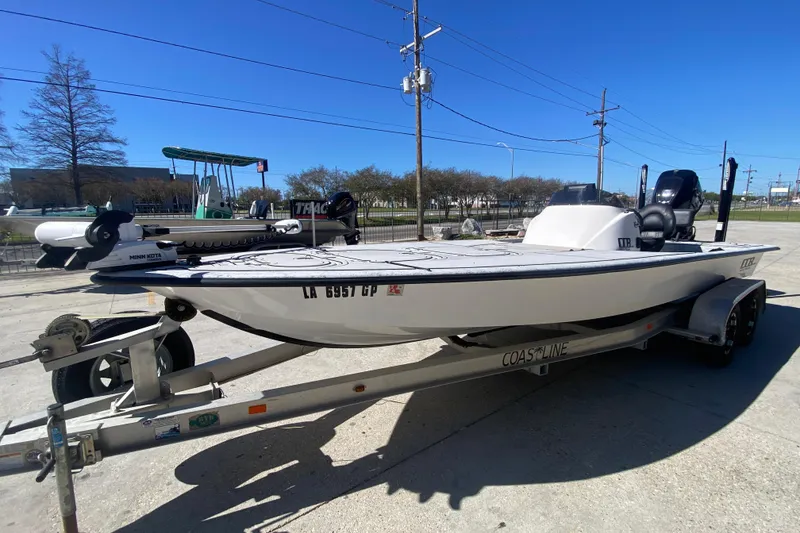 Slide: The Image of 2020 Coastal Custom Boats 23' Fury on trailer, parked outdoors under clear blue sky. - 8