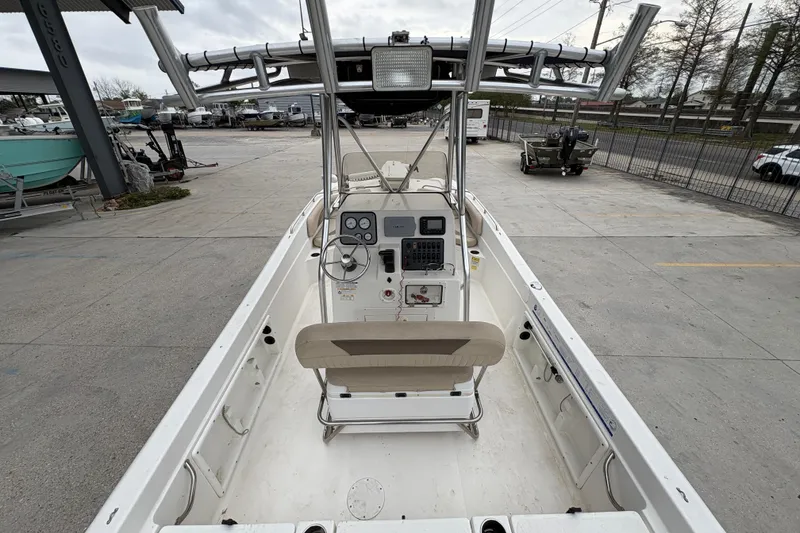 Slide: The Image of 2014 NauticStar 210 Coastal boat interior with steering console and seating. - 12