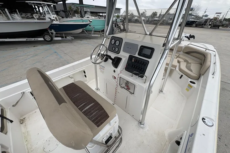 Slide: The Image of 2014 NauticStar 210 Coastal boat interior with steering console and seating. - 13