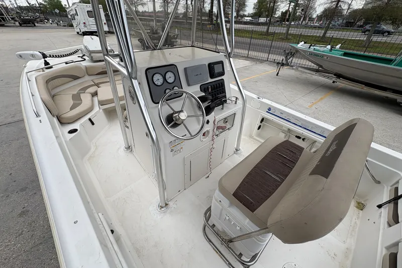 Slide: The Image of 2014 NauticStar 210 Coastal boat interior with steering console and seating. - 14