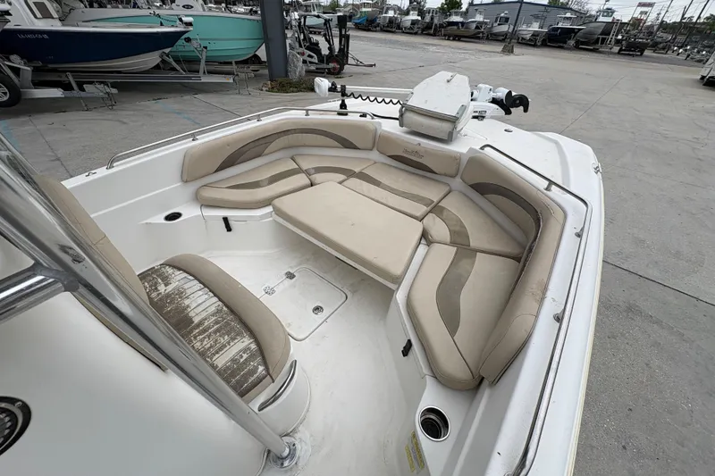 Slide: The Image of 2014 NauticStar 210 Coastal boat interior with cushioned seating and storage compartments. - 16