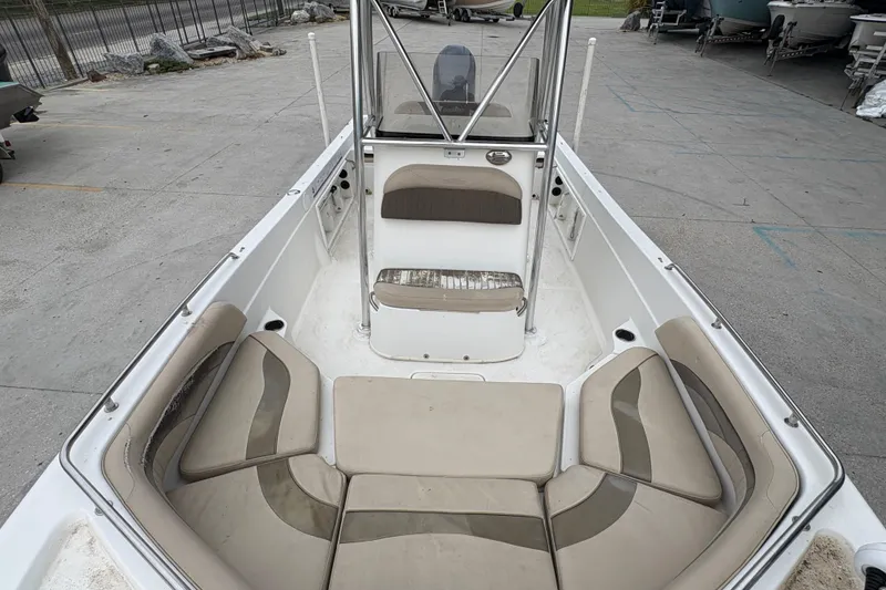 Slide: The Image of 2014 NauticStar 210 Coastal boat interior with cushioned seating and console. - 17