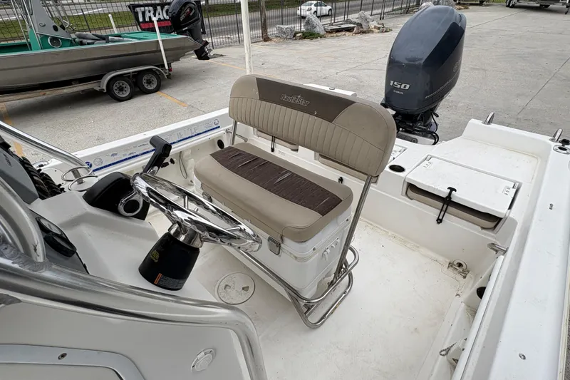 Slide: The Image of 2014 NauticStar 210 Coastal boat interior with steering wheel and seating. - 20