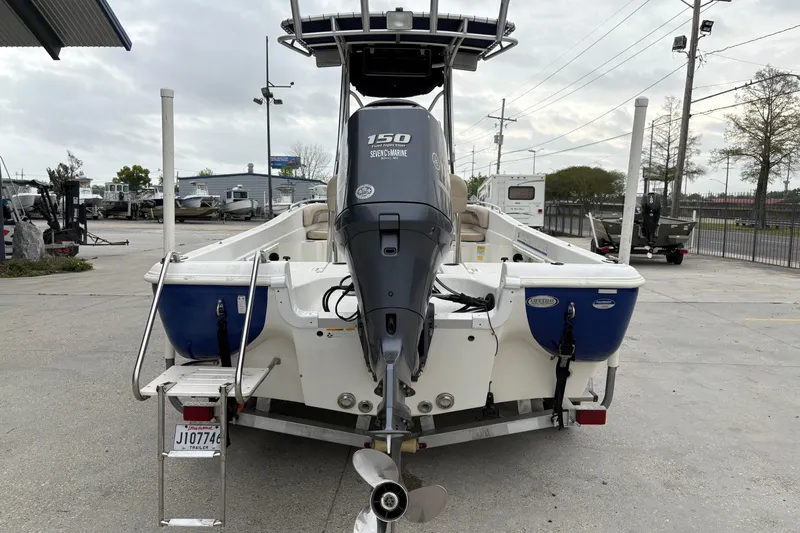 Slide: The Image of 2014 NauticStar 210 Coastal boat with Yamaha 150 engine, parked in a marina. - 5