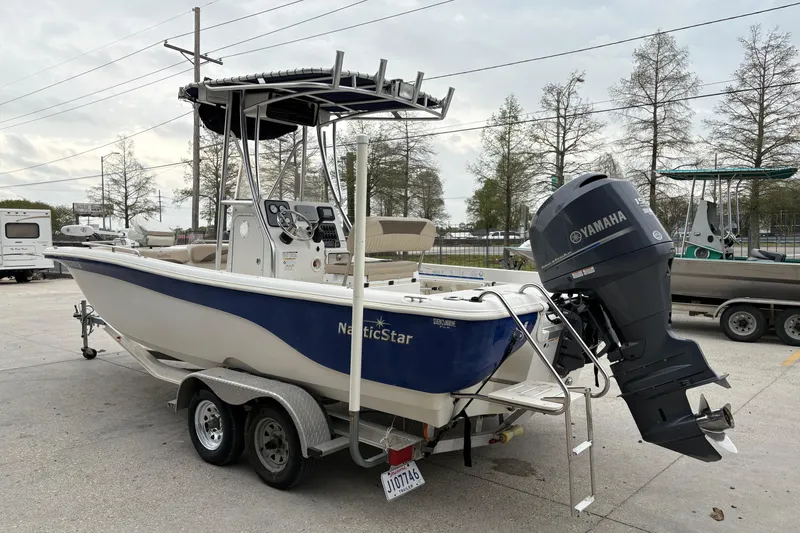 Slide: The Image of 2014 NauticStar 210 Coastal boat with Yamaha outboard motor on trailer. - 6
