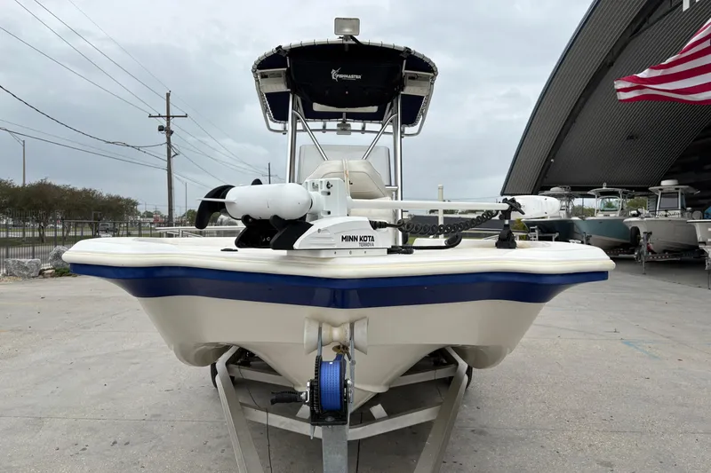 Slide: The Image of 2014 NauticStar 210 Coastal boat on trailer, featuring Minn Kota trolling motor. - 9