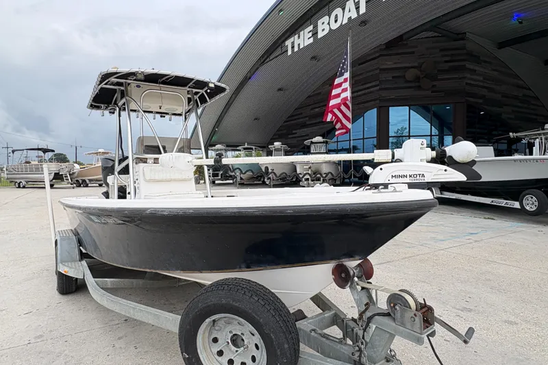 Slide: The Image of Kenner 21 VISION 2000 boat on trailer outside dealership with American flag. - 10