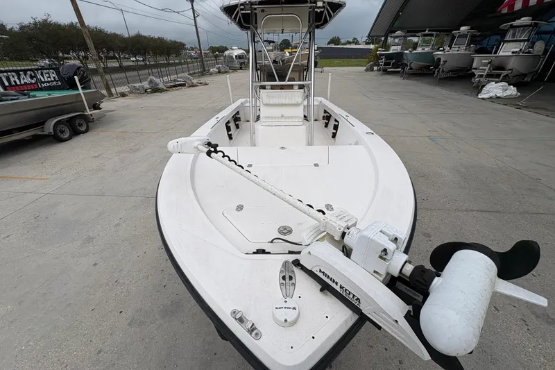 Slide: The Image of Kenner 21 VISION boat, 2000 model, with trolling motor, parked outdoors. - 11