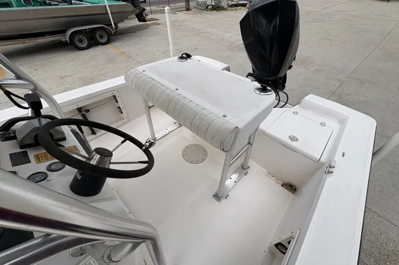 Slide: The Image of Interior of a 2000 Kenner 21 VISION boat with steering wheel and seating. - 18