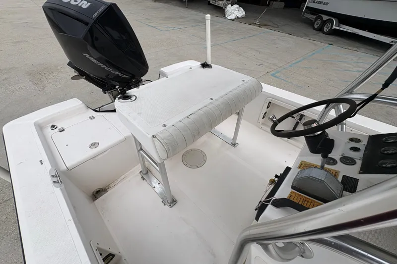 Slide: The Image of Kenner 21 VISION 2000 boat interior with steering wheel and Mercury outboard motor. - 19