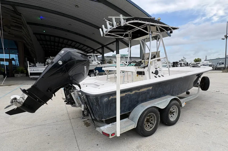 Slide: The Image of Kenner 21 VISION 2000 boat on trailer with outboard motor, parked outdoors. - 4