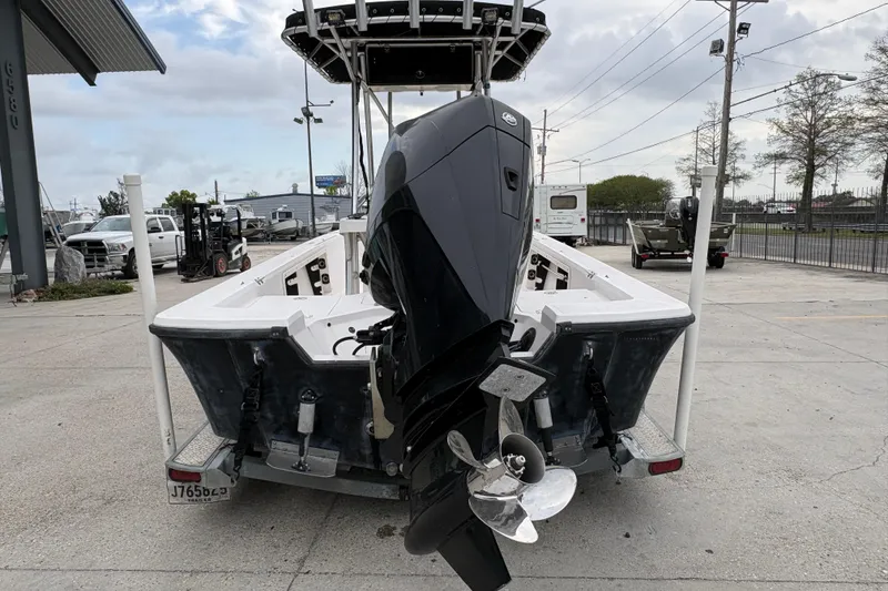 Slide: The Image of 2000 Kenner 21 VISION boat with outboard motor on trailer in parking lot. - 5