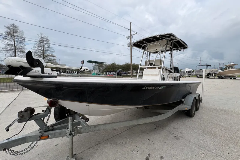 Slide: The Image of 2000 Kenner 21 VISION boat on trailer, parked outdoors under cloudy sky. - 8