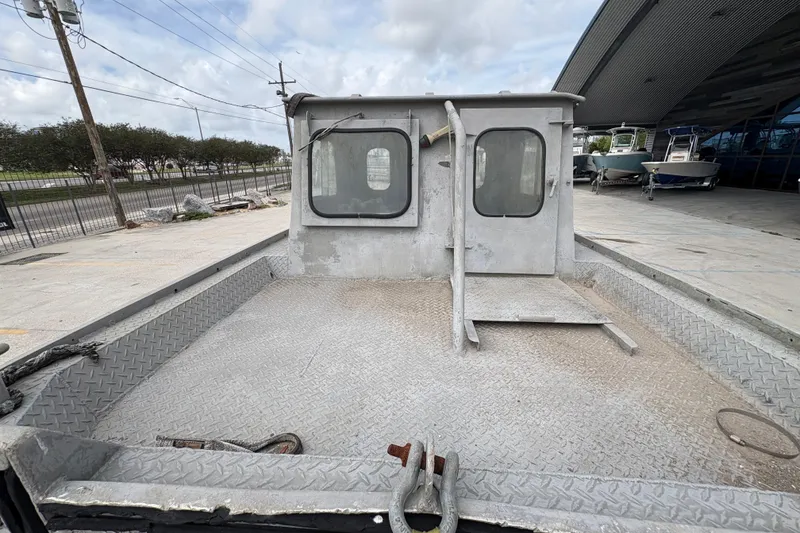Slide: The Image of 1972 Custom 23' work/push boat with metal deck and cabin, docked outdoors. - 11