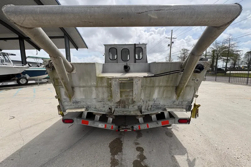 Slide: The Image of Rear view of a 1972 Custom 23' work/push boat on a trailer. - 5