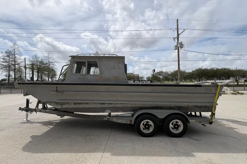 Slide: The Image of 1972 Custom 23' work/push boat on trailer, parked outdoors under cloudy sky. - 7