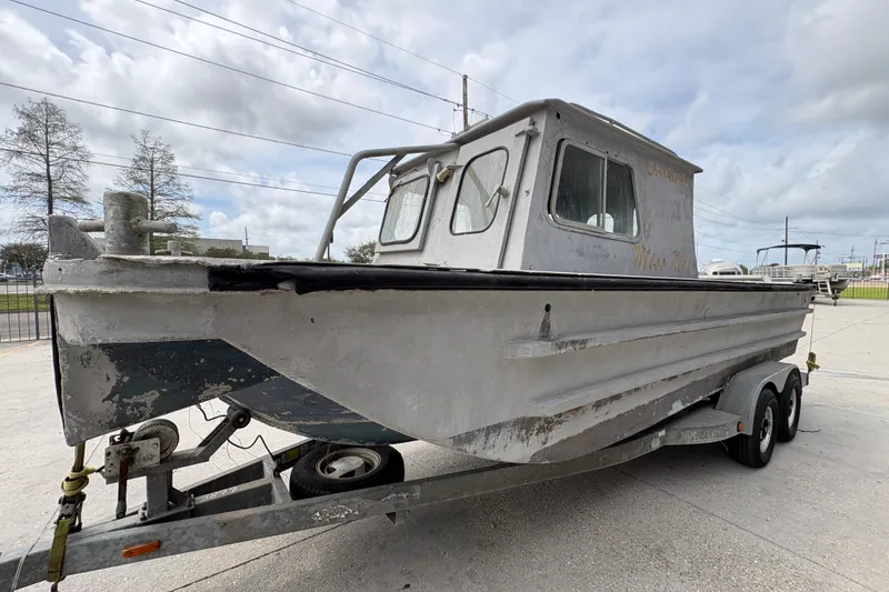 Slide: The Image of Vintage 1972 custom 23' work/push boat on trailer, weathered exterior, cloudy sky background. - 8