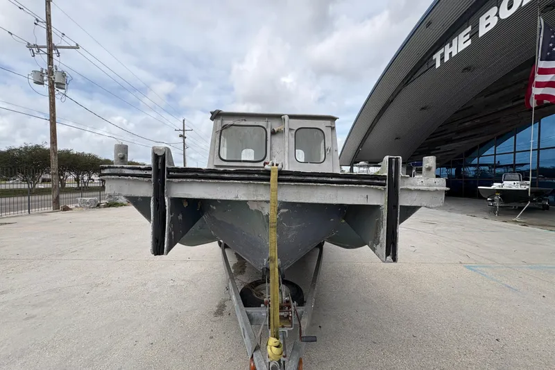 Slide: The Image of Front view of a 1972 custom 23' work/push boat on a trailer, outside a building. - 9