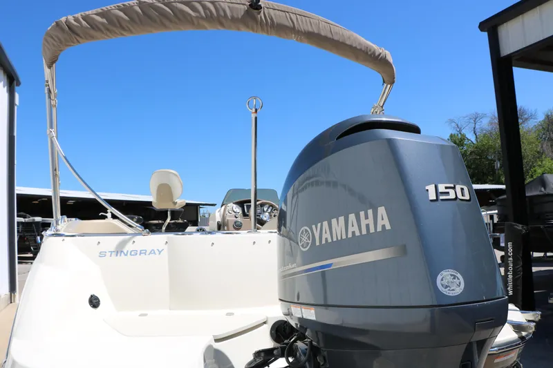 Slide: The Image of 2015 Stingray 192 SC boat with Yamaha 150 outboard motor, under clear blue sky. - 11