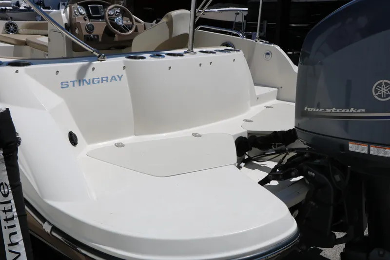 Slide: The Image of 2015 Stingray 192 SC boat with Yamaha four-stroke engine, featuring spacious deck and seating. - 15