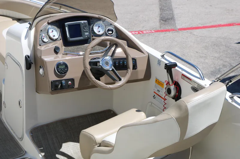 Slide: The Image of 2015 Stingray 192 SC boat cockpit with steering wheel and control panel. - 22