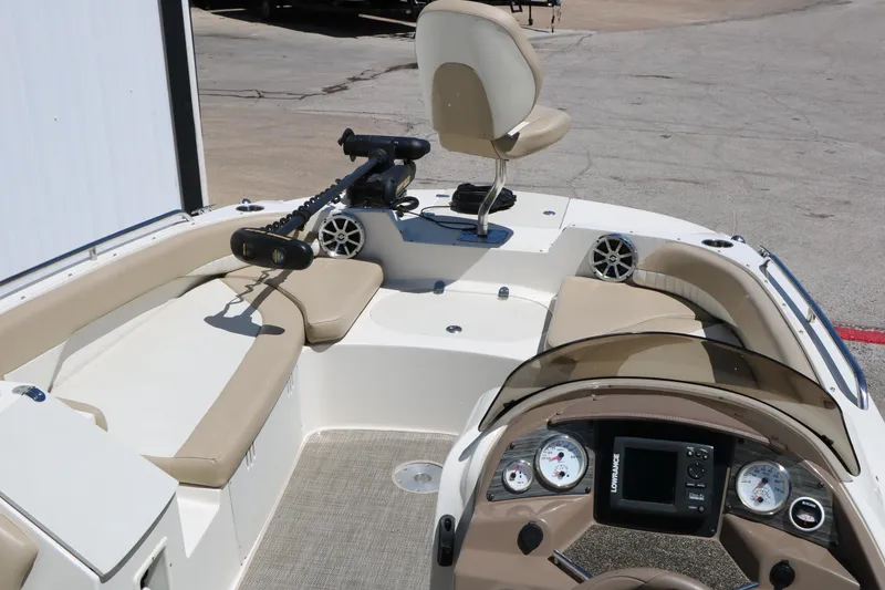 Slide: The Image of 2015 Stingray 192 SC boat interior with seating, steering console, and mounted equipment. - 25