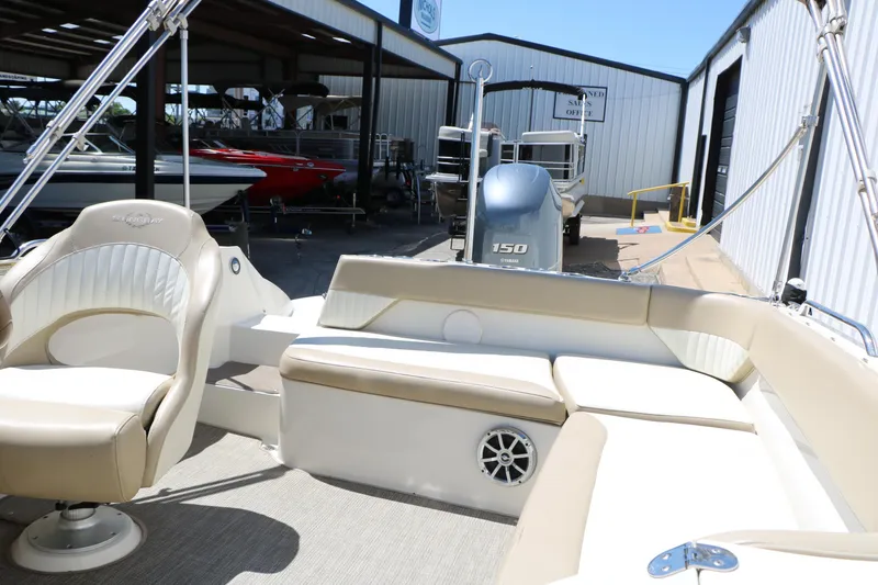 Slide: The Image of 2015 Stingray 192 SC boat interior with beige seating and Yamaha 150 engine. - 30