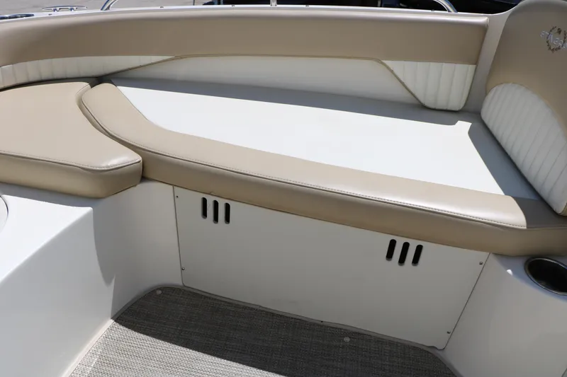 Slide: The Image of 2015 Stingray 192 SC boat interior with beige seating and storage compartment. - 32