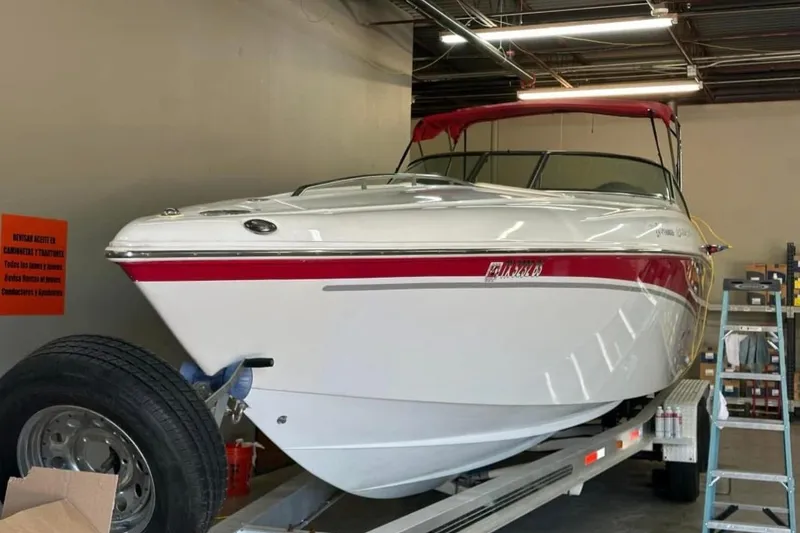 Slide: The Image of 2005 Baja 342 Boss boat with red accents on a trailer in a garage. - 3
