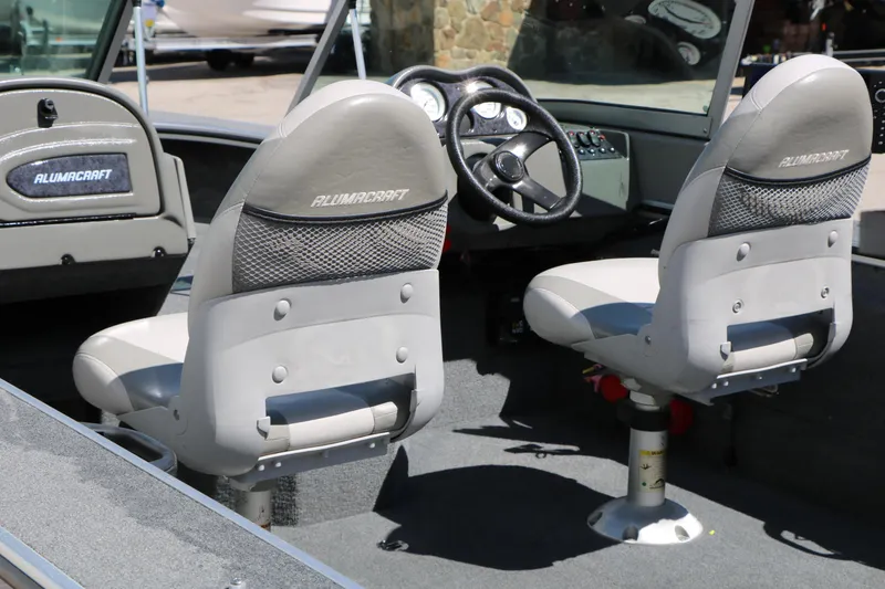 Slide: The Image of 2008 Alumacraft Dominator 165 Sport boat interior with steering wheel and seats. - 12