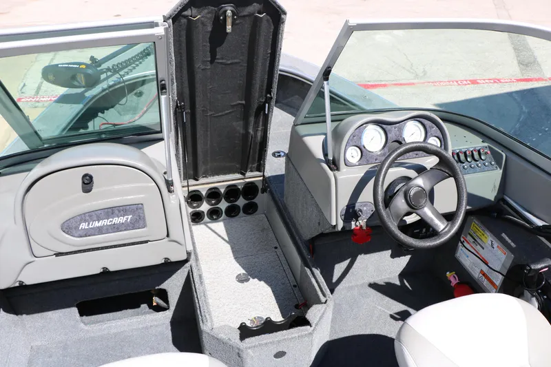 Slide: The Image of 2008 Alumacraft Dominator 165 Sport boat interior with steering wheel and dashboard controls. - 21
