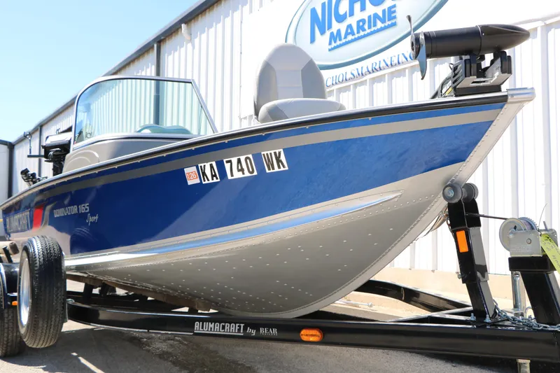 Slide: The Image of 2008 Alumacraft Dominator 165 Sport boat on trailer, blue and silver design. - 3
