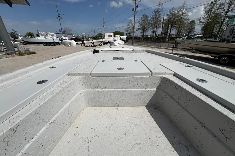 Slide: The Image of 2020 Blazer Bay 2170 boat interior with storage compartments, parked outdoors. - 13