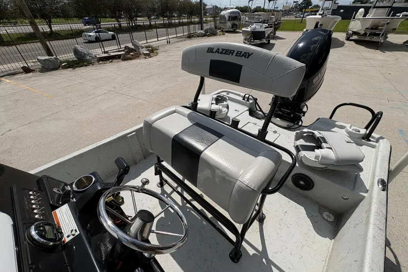 Slide: The Image of 2020 Blazer Bay 2170 boat interior with steering wheel and seating. - 17