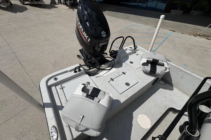 Slide: The Image of 2020 Blazer Bay 2170 boat with Suzuki outboard motor, docked on concrete surface. - 19