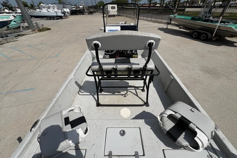 Slide: The Image of 2020 Blazer Bay 2170 boat interior with seating and console in a marina setting. - 22