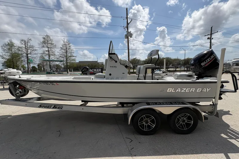 Slide: The Image of 2020 Blazer Bay 2170 boat on trailer, parked outdoors under cloudy sky. - 7