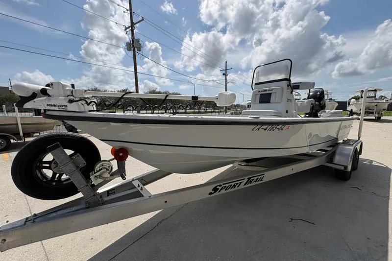 Slide: The Image of 2020 Blazer Bay 2170 boat on trailer under cloudy sky. - 8